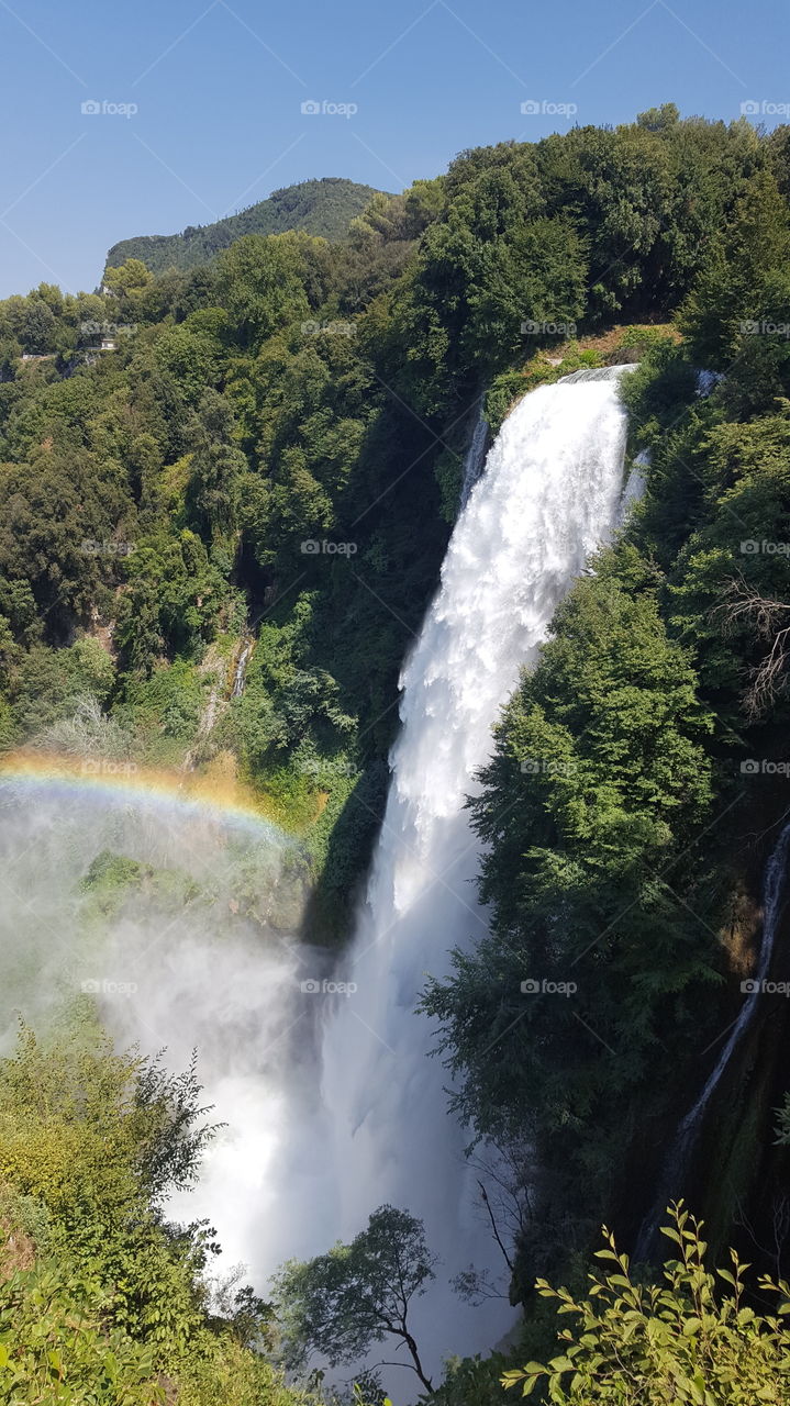 Roman made waterfall in Italy creating rainbow in water vapour.
