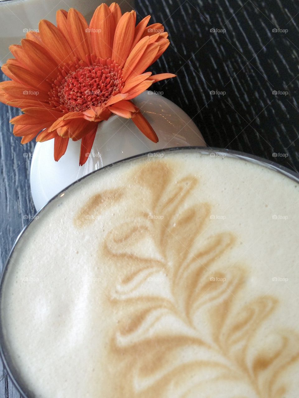 A cup of coffee and flower.