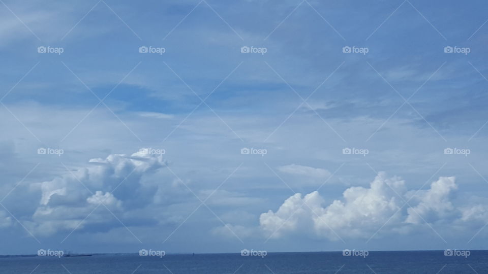 The clouds dance above the open water.