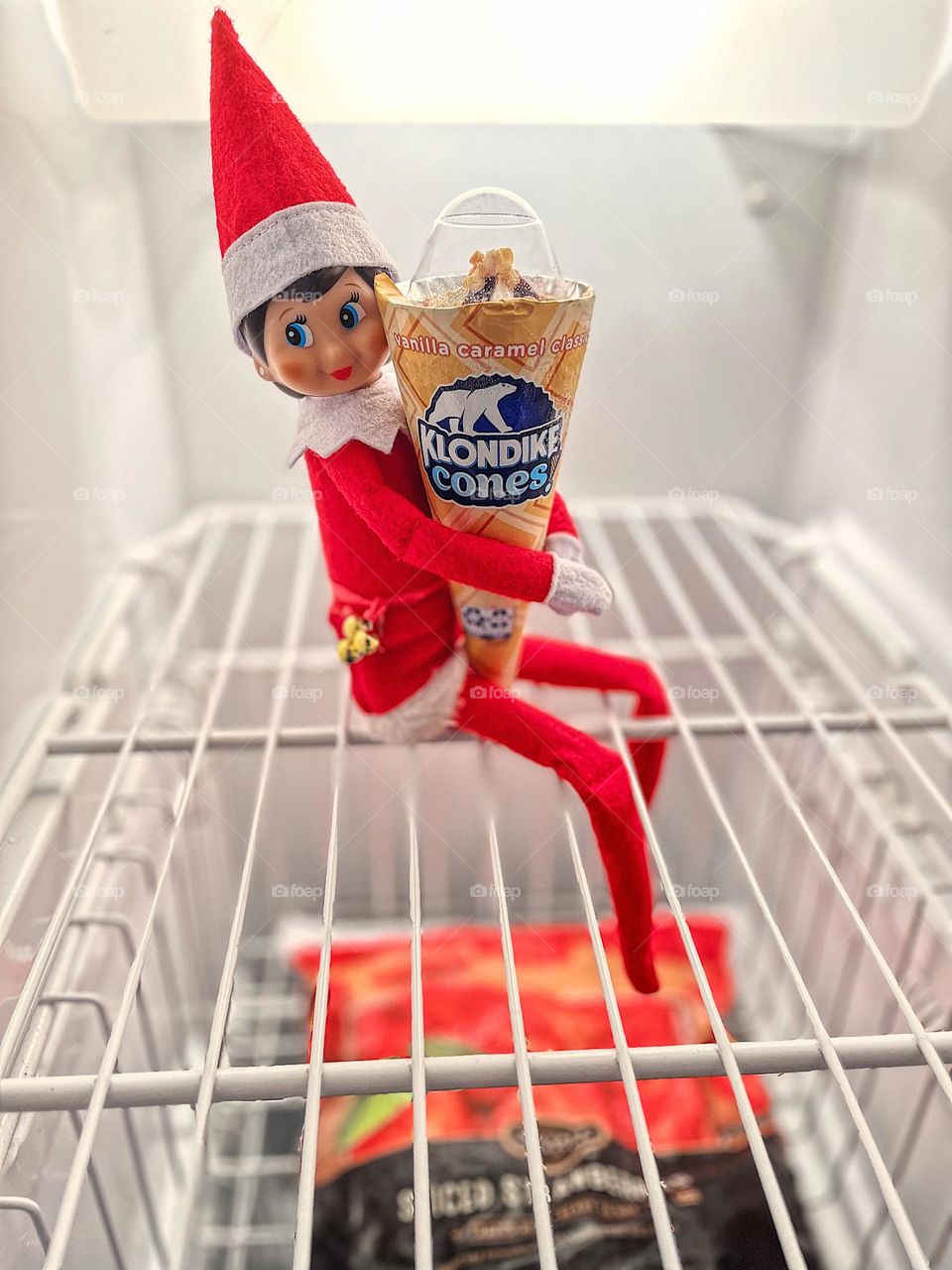 Elf on the Shelf in the freezer, what would you do for a Klondike?, elf on a shelf hugs a Klondike cone, elf on the shelf hiding in the freezer, silly elf antics, Christmas traditions with kids, Elf on the Shelf 