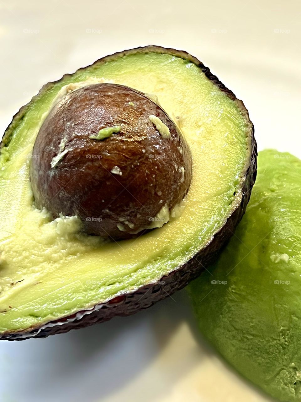 Avocado cut into two halves shot close-up