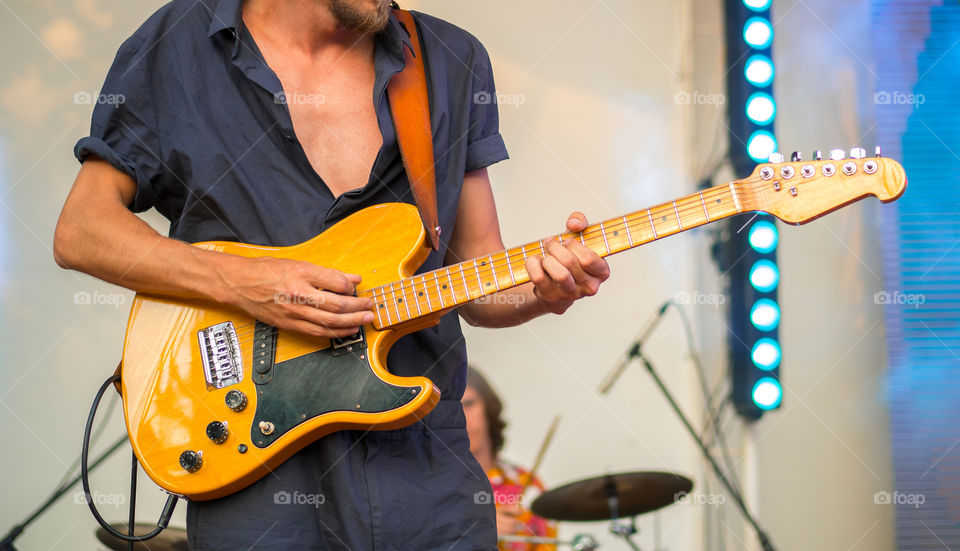 Guitarist playing while music festival 