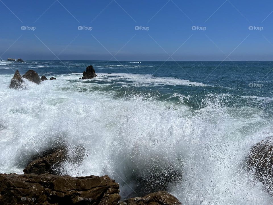 Huge wave crashing on Little Corona del Mar Beach