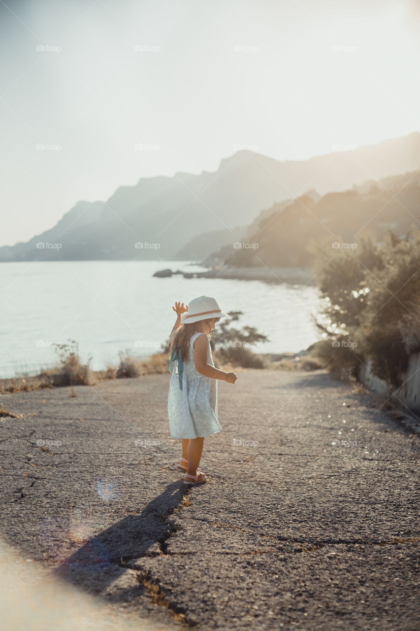 Little girl on the sea coast