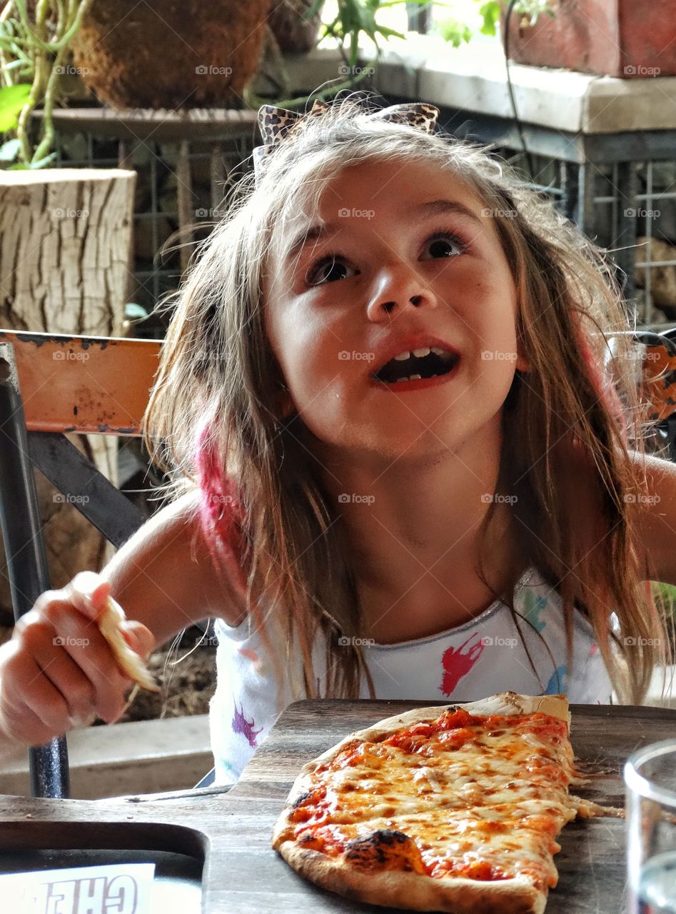 Happy Girl Eating Pizza. Young Girl With Messy Hair Eating Pizza
