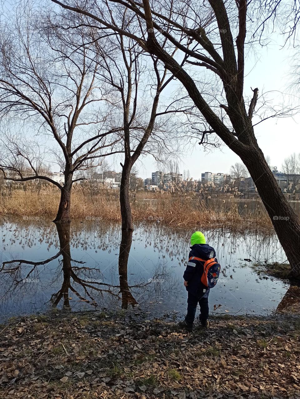 little boy on the spring river coast