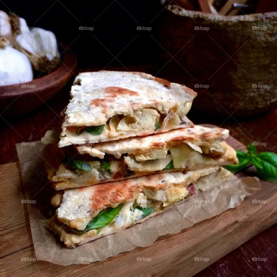 Artichoke and hummus panini with fresh basil and garlic.