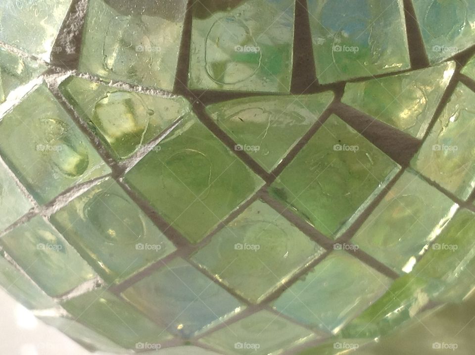 A diamond and square pattern glass candleholder.