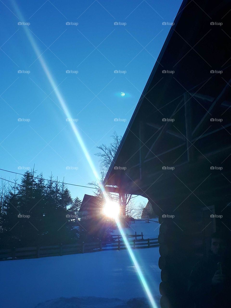 sunset on the beard behind the mountain cottages