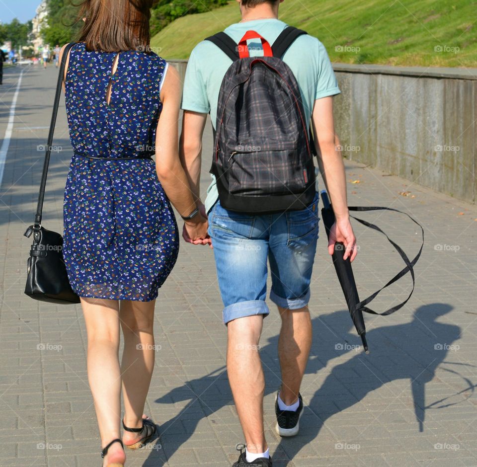 happy couple walking on a street summer time