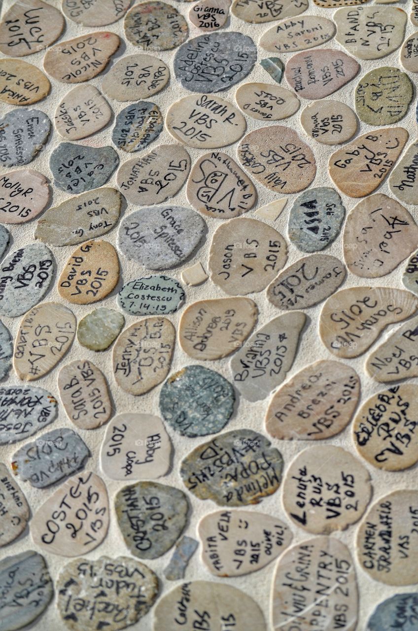 Grey stones with names written on them, a memory of the people who had a good time together and of the good times they had. 