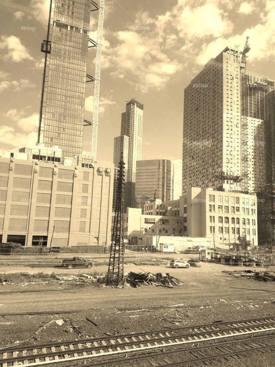 View of Long Island City train tracks taken aboard the Long Island Rail Road (LIRR) morning commute into Manhattan from Queens. Sepia Filter. June 2017.