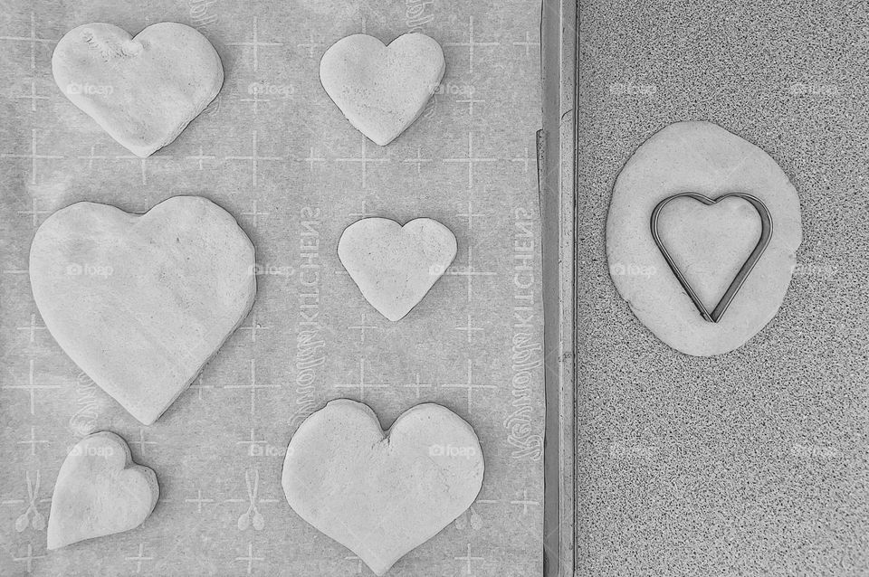 White hearts ready to bake, making heart ornaments out of salt dough, salt dough hearts, decorations for Valentine’s Day, gifts for friends and family, making ornaments, white dough makes white hearts, making hearts in the kitchen