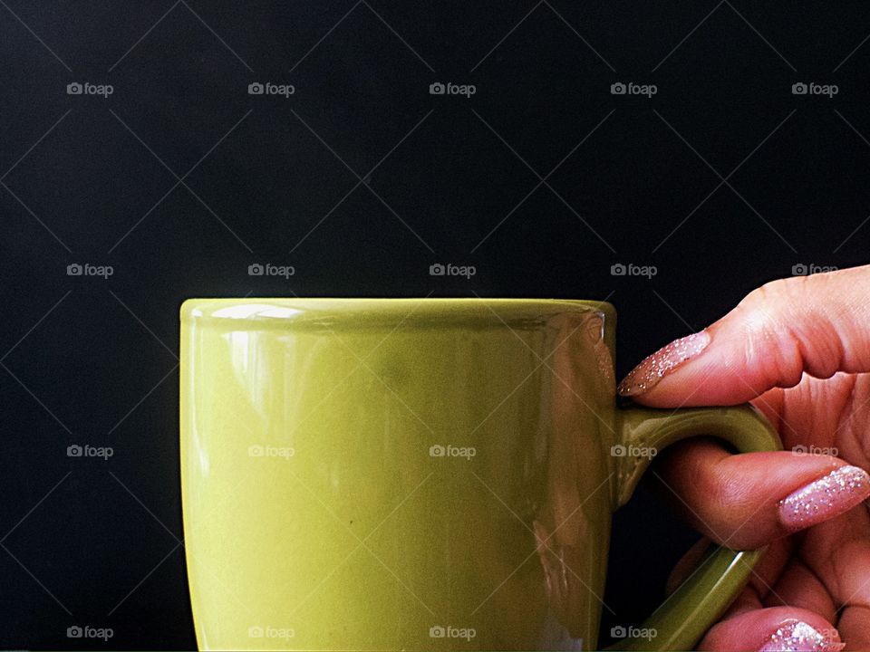 Hand holding a cup of tea 