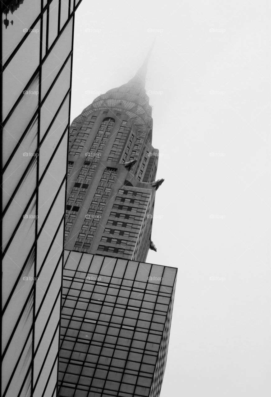 monochrome skyscaper scene in New York City with the Chrysler Building covered in fog
