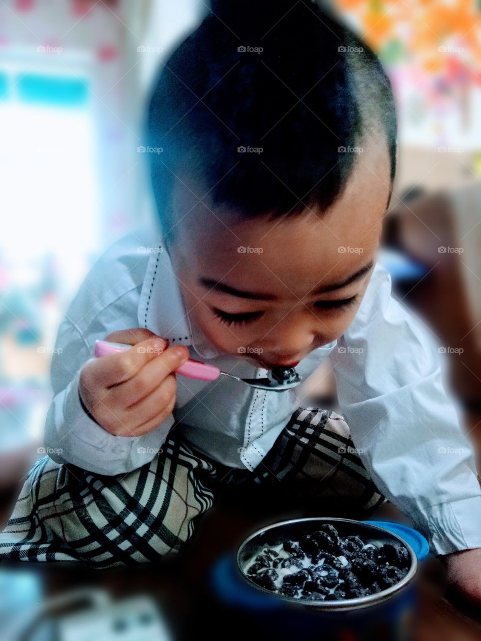 early morning is a busy day and this kid is in rush to go to school, so he is eat his favorite cereal with milk to make his day good,  make him healthy even without rice and to save time.
