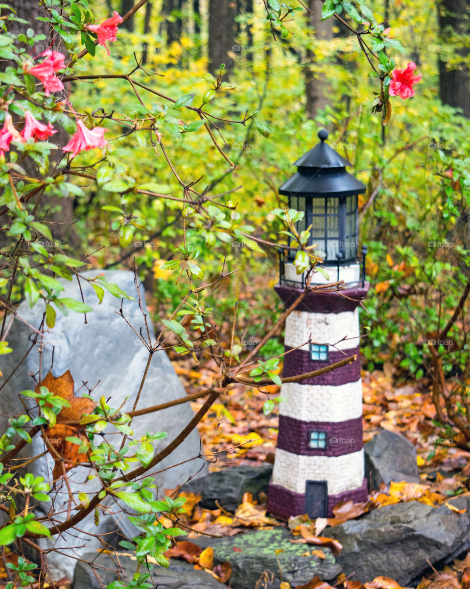 Garden lighthouse in the autumn 