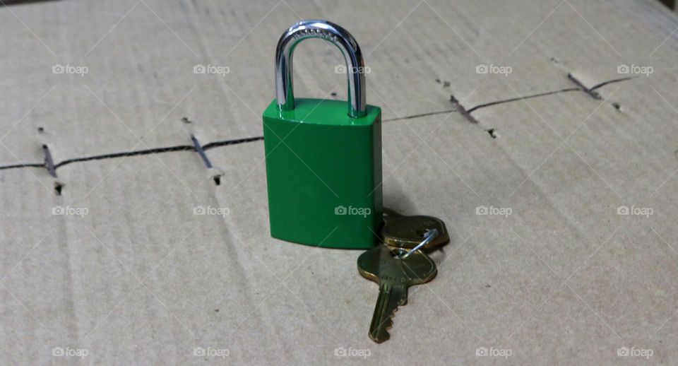 Photo of a pair of green locks and keys