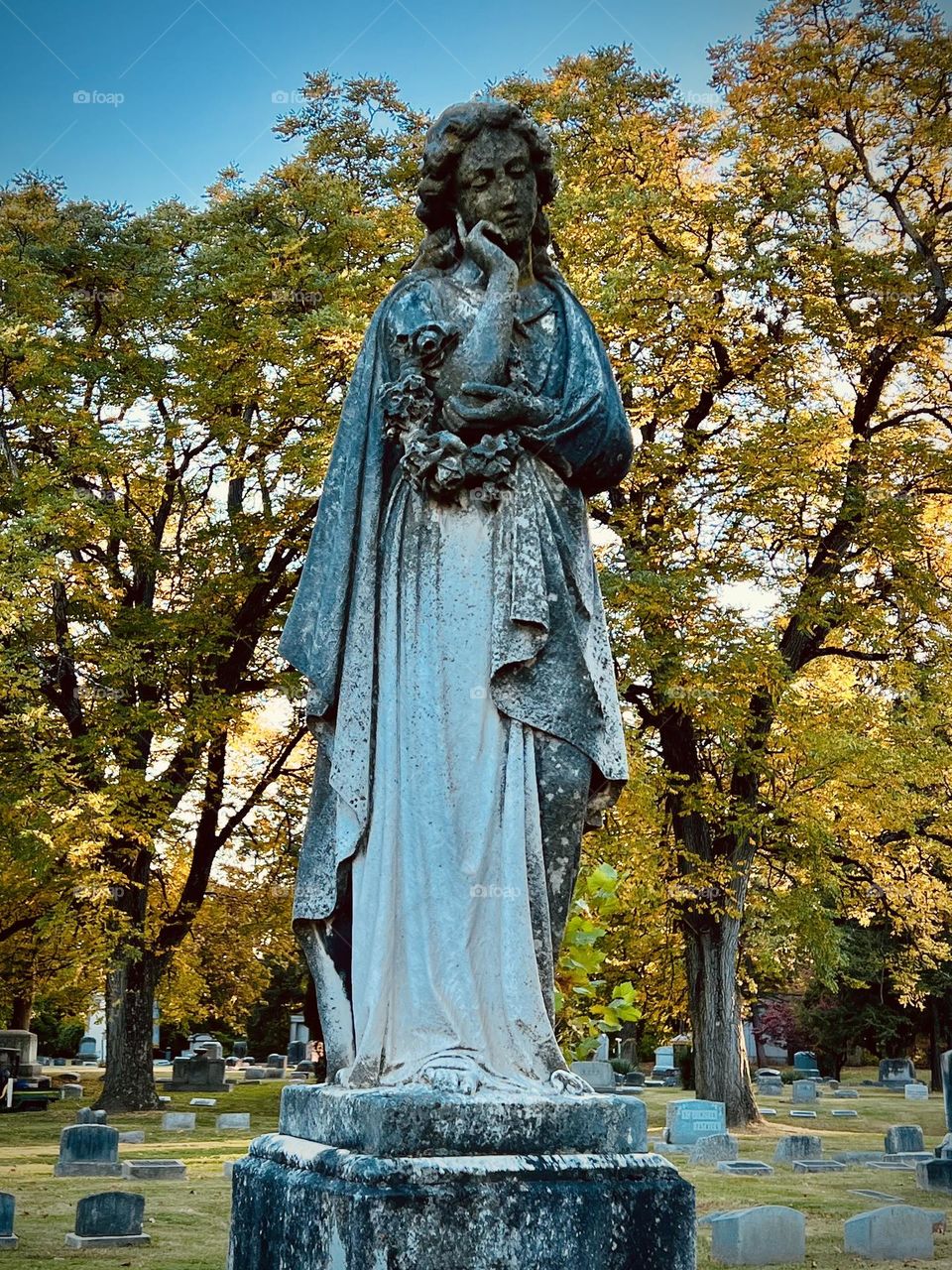 A hauntingly beautiful grave stone in an old cemetery 