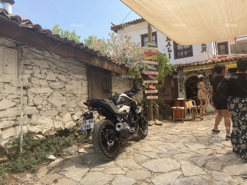Greek village in Turkey. Blue sky and tall palm trees. Sunsets and sunny days. Summertime in Kusadasi. Vacation travel in Turkey . Summer view. Sunny day during vacation 