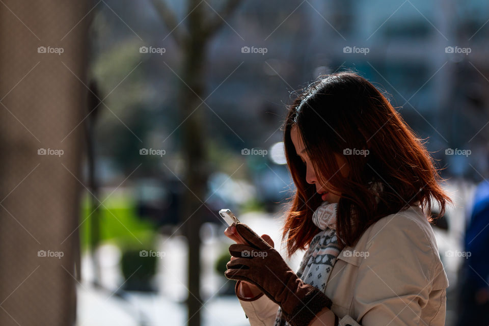 Girl playing smartphone 