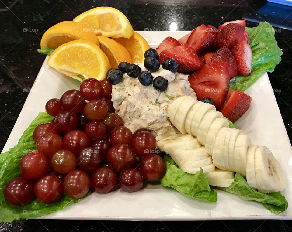 Fresh summer salad with tuna and assorted fruit 