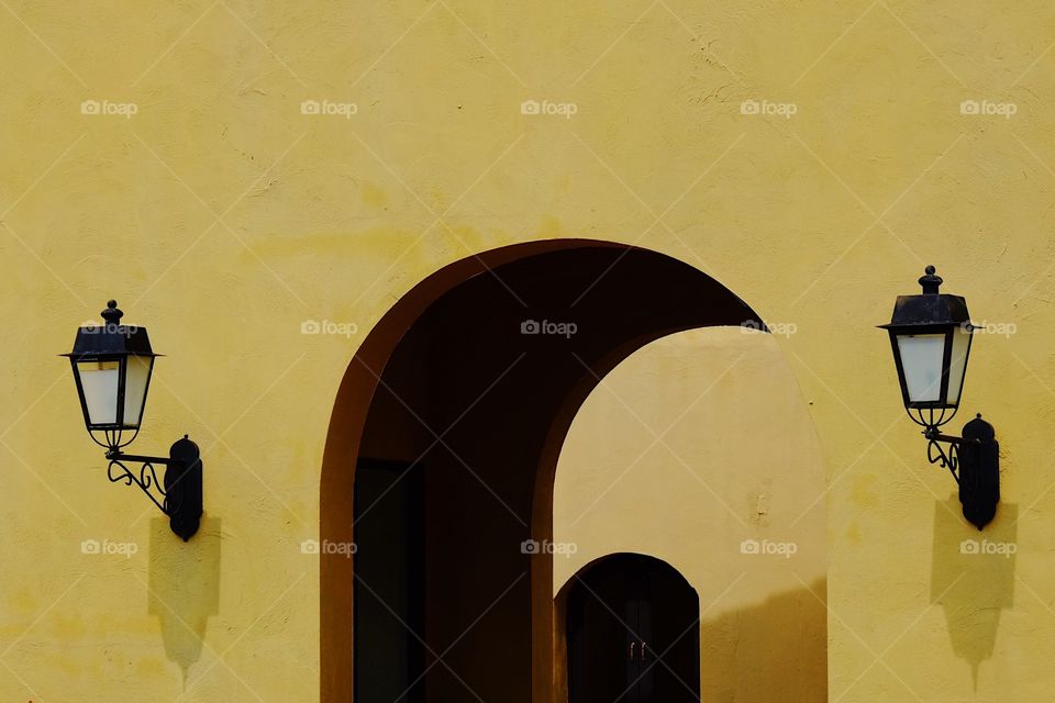 Lamp on yellow wall 