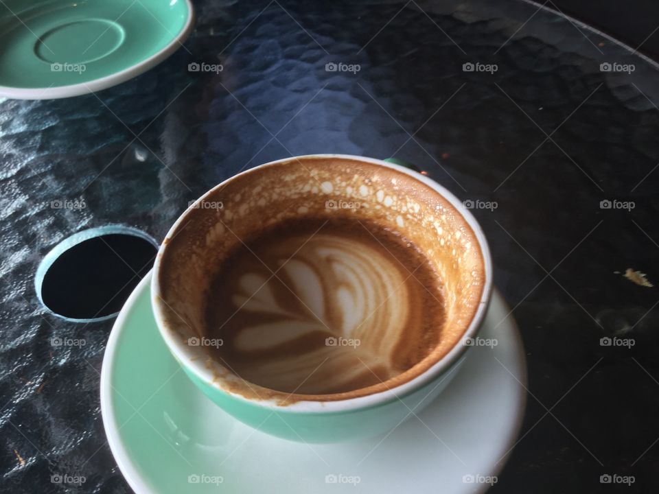 Cappuccino with a leaf in the foam
