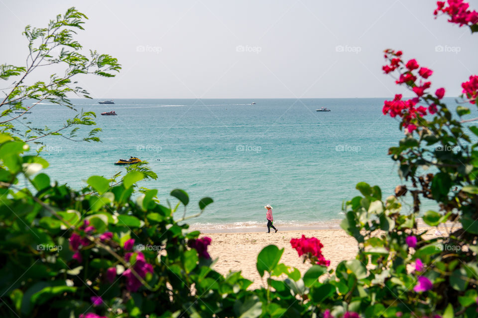 A woman is walking on the beach