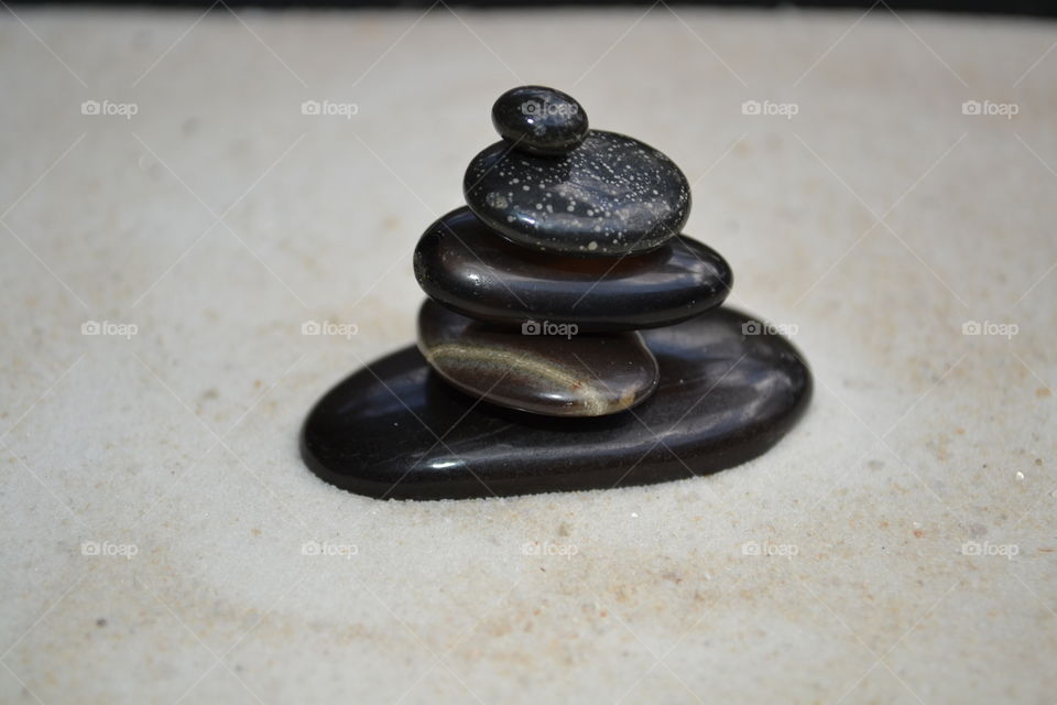 Arrangement of pebbles on sandy beach