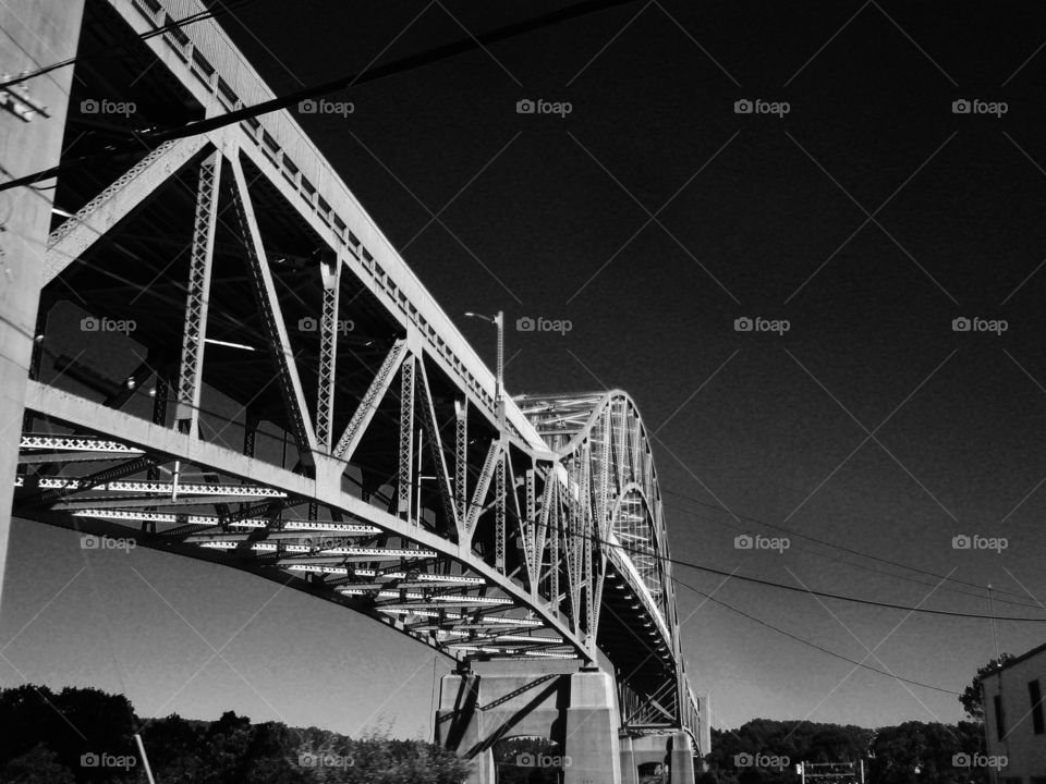 Sagamore Bridge connecting Massachusetts to Cape Cod. Pic taken looking up at bridge.

There are two identical bridges that are like this photo. This Canal saves much time for boats & ships for whatever their reason from going all the way around the Cape.