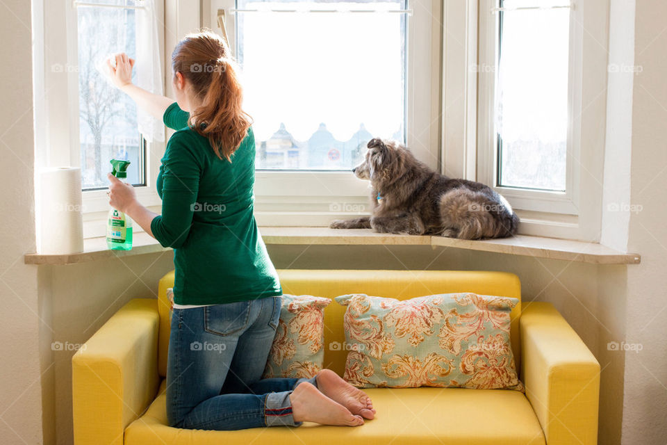 Woman cleaning window