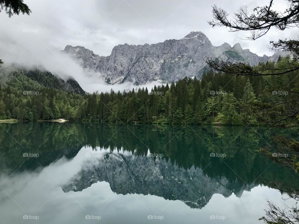 Lake mirroring mountains in Italy