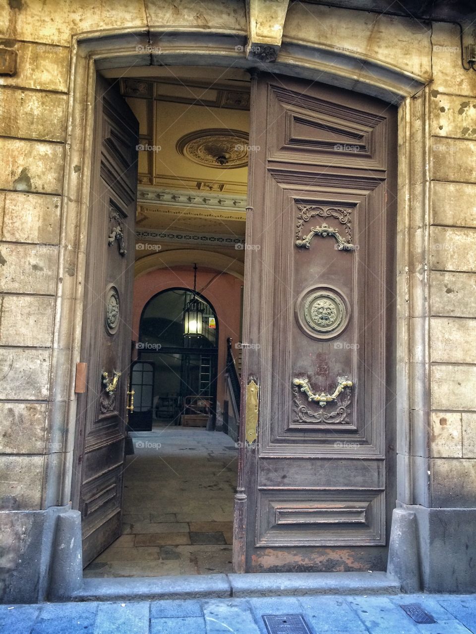 Old wooden doors with bronze elements. Outdoor  view.
