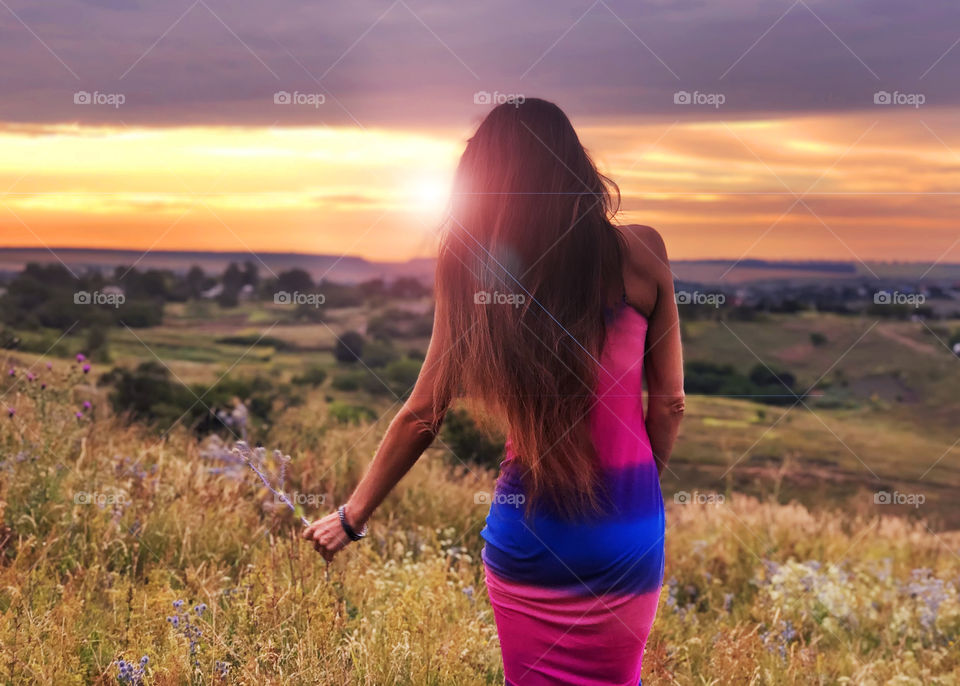 Young woman with long hair in the field 
