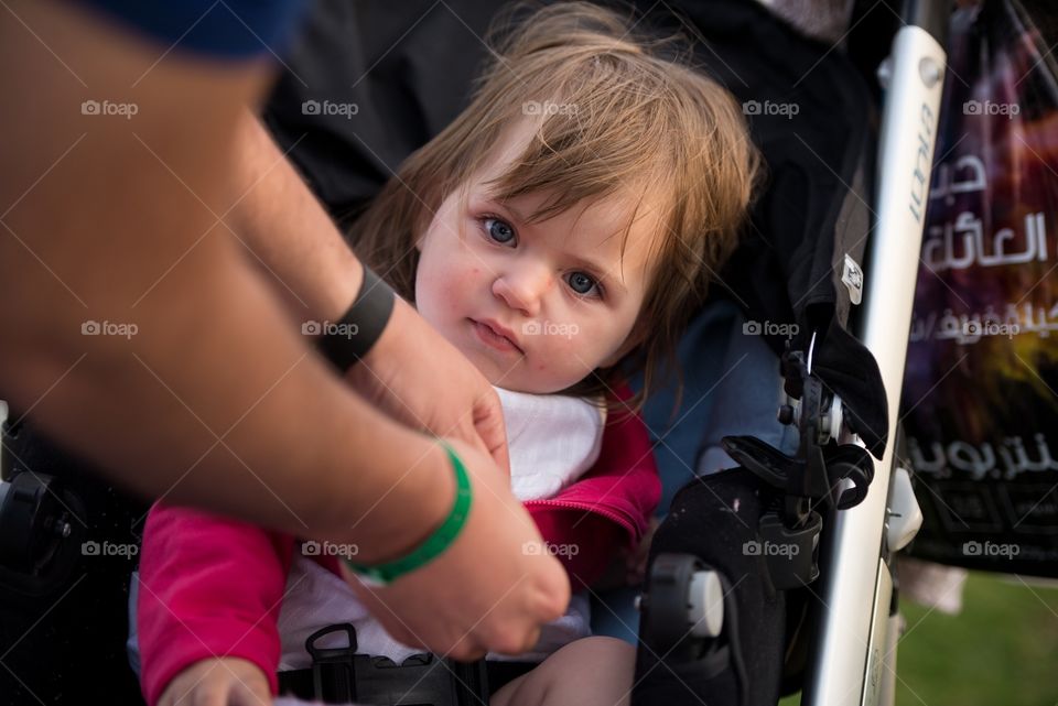 sleepy baby girl in her stroller