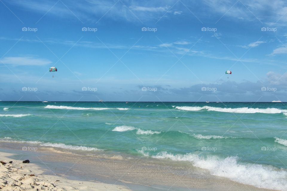 Paragliding flying under caribbean sea