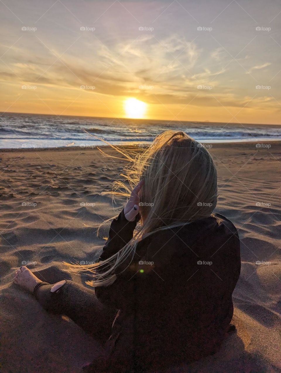 happiness on the beach at sunset sitting in the sand watching the ocean and sunset vacation vibes glimmers mission