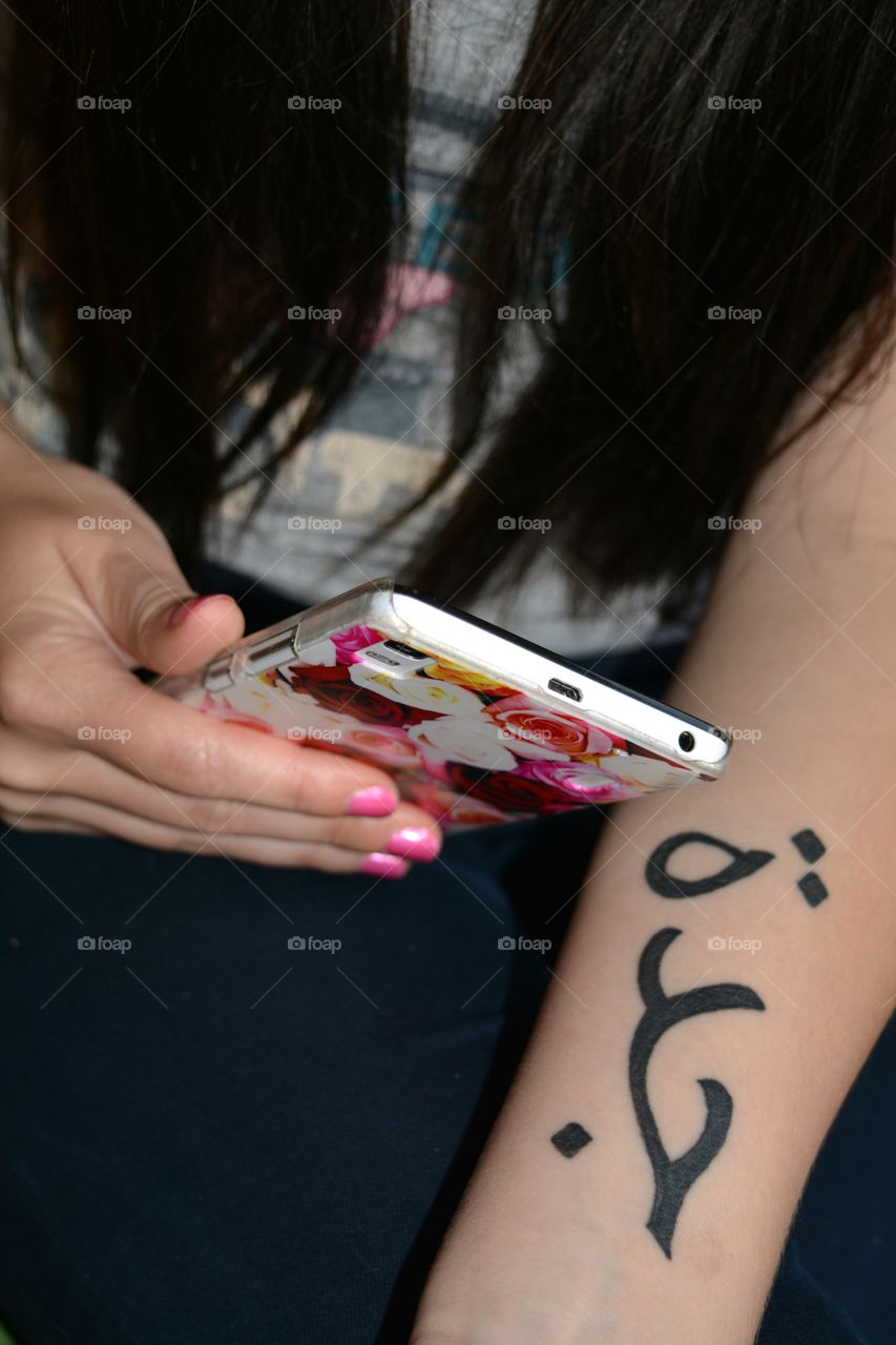 tattoo on the hand girl and smartphone