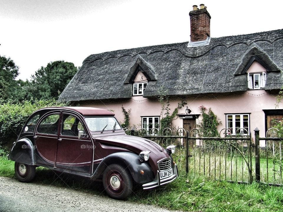 Old car by an old house