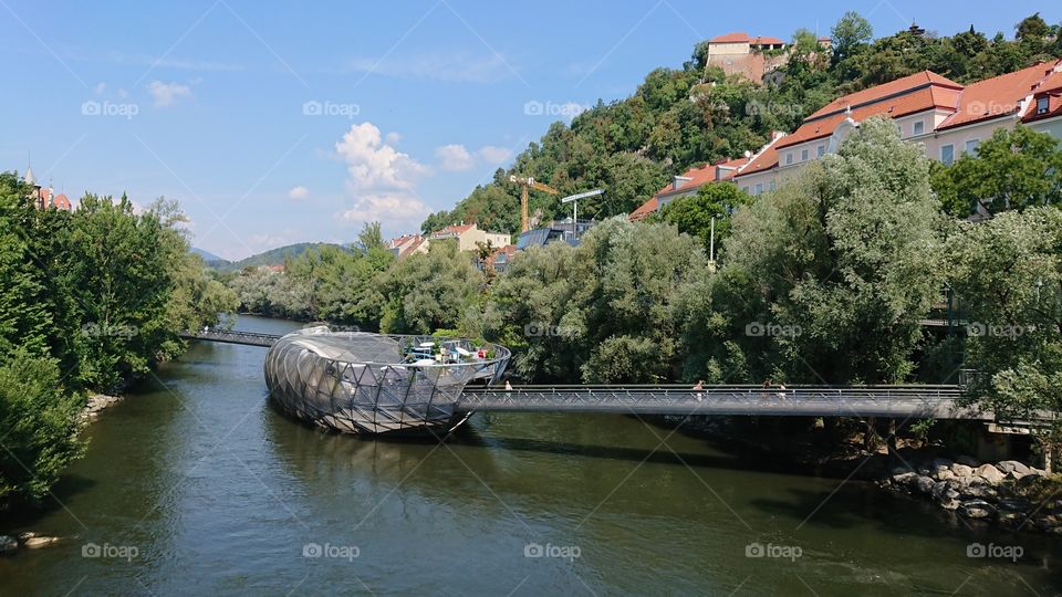 Murinsel is an artificial bridge island over the waters of the Mur river in the Austrian city of Graz. It was conceived by the artist Vito Acconci in 2003, year in which Graz held the title of European cultural capital.