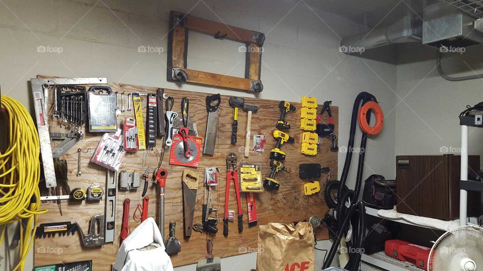 tool peg board with variety of tools in maintenance shop