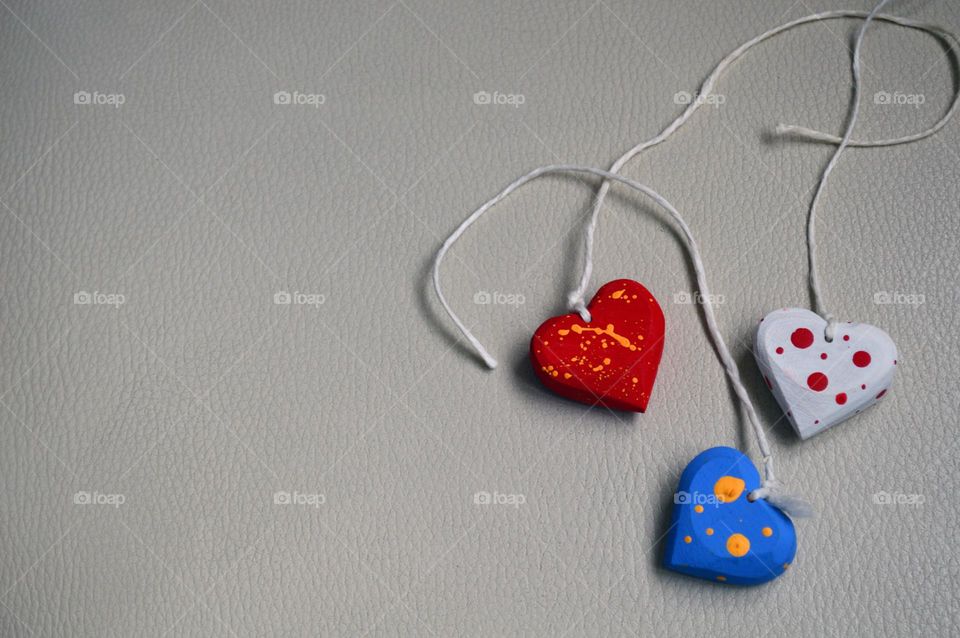 Multicolored wooden hearts on a thread