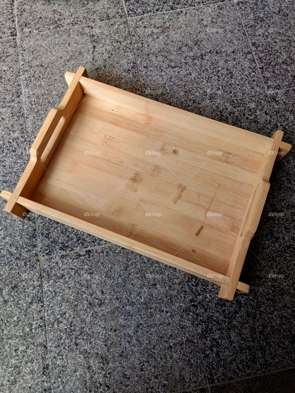 Bamboo tray isolated on a black ceramic background, top view. Save the cliping path.