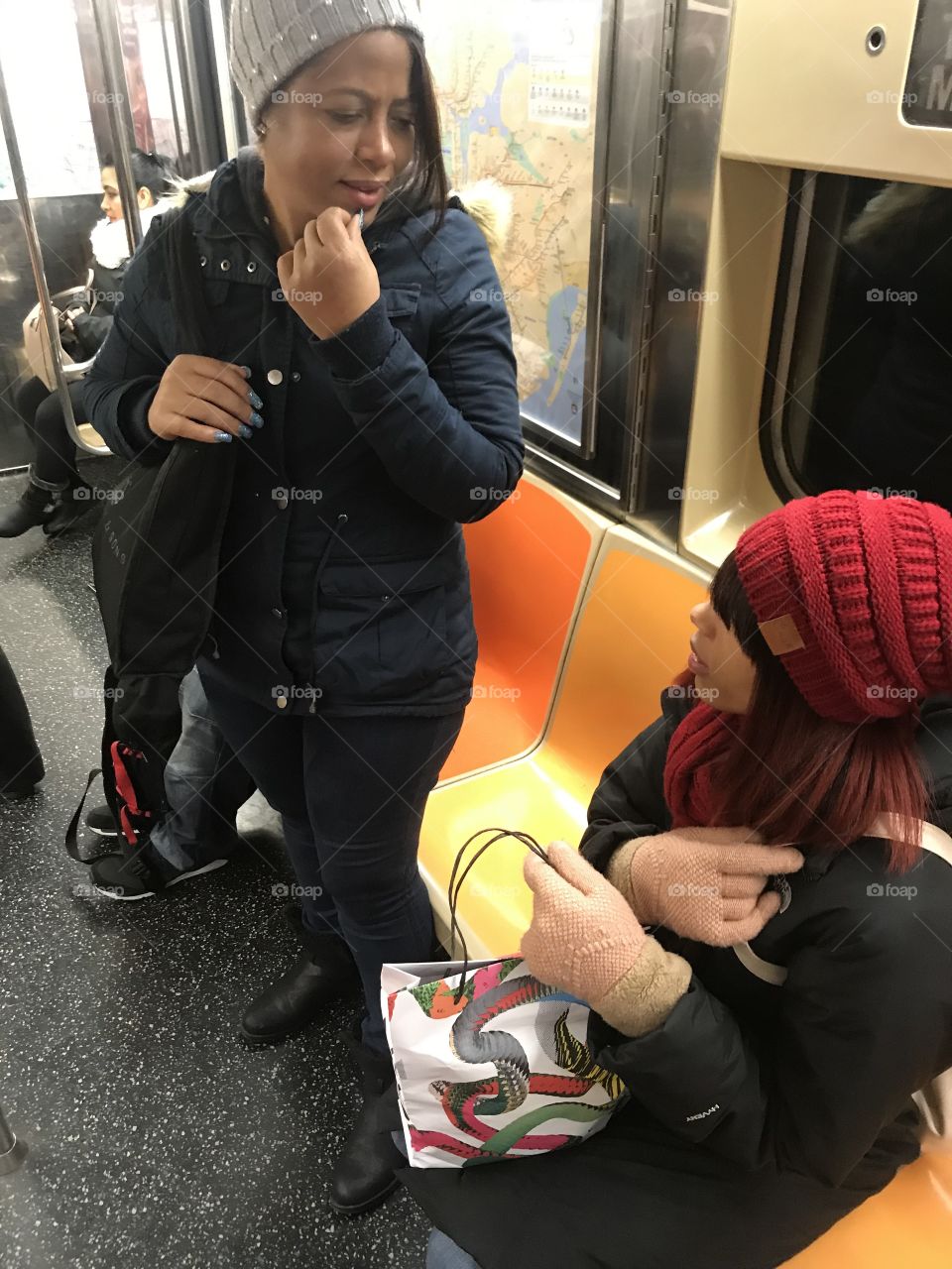 Two pretty girls discussing matters in Spanish early Sunday morning in Times Square on the S Shuttle Train.