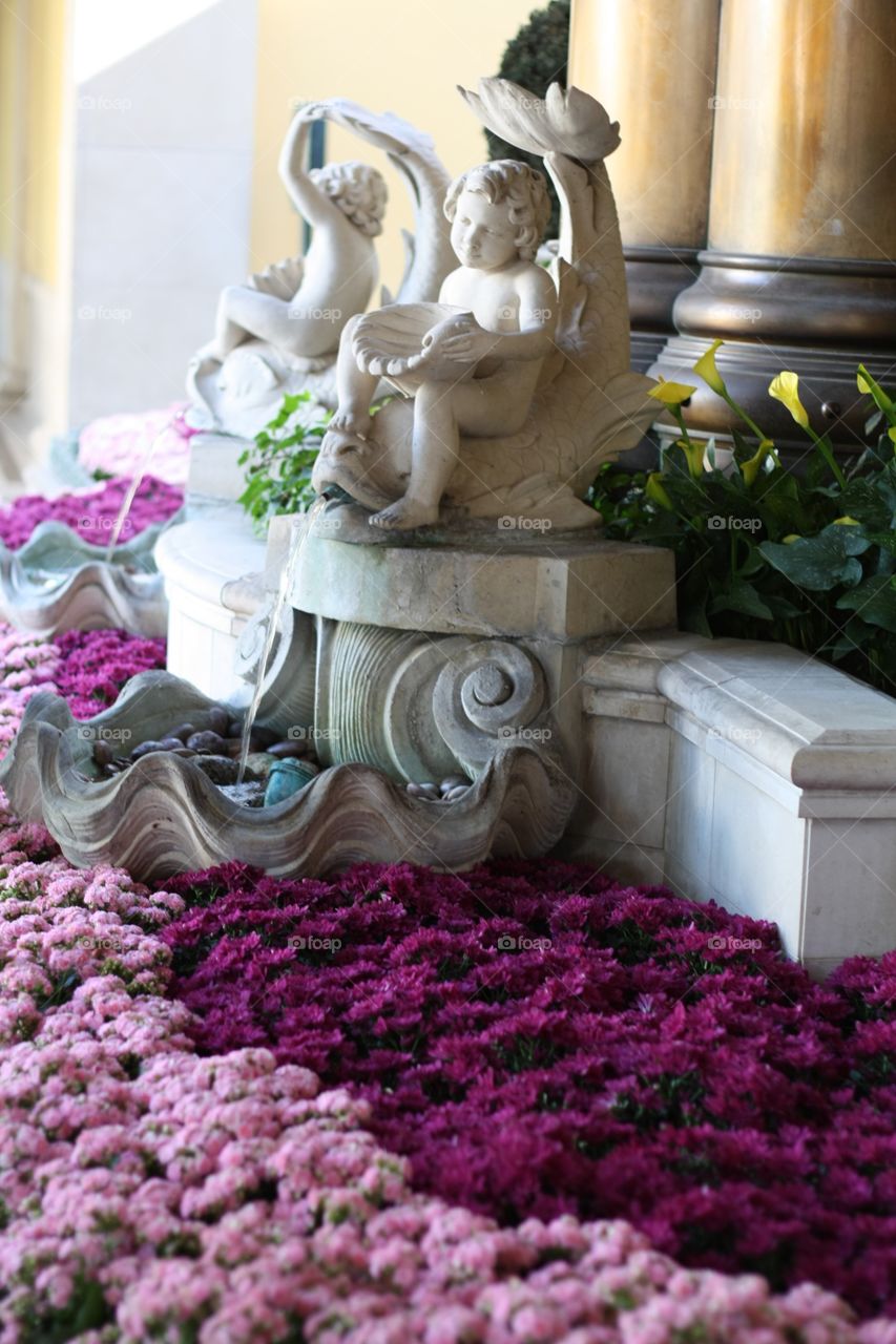 Purple flowers and statue