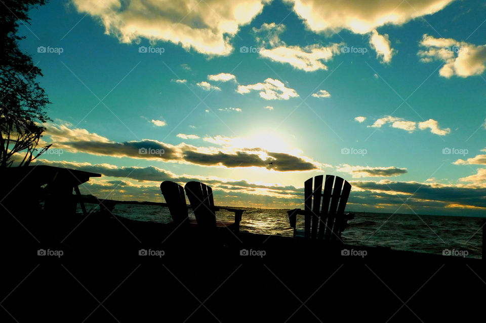 Amazing silhouette of two beach chairs 