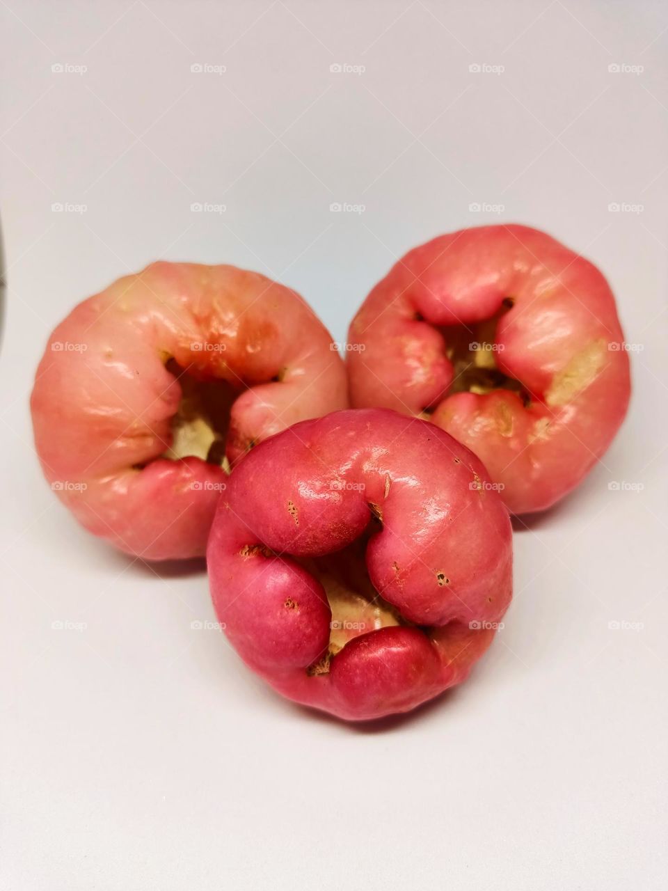 Close up of wax apple isolated on white background. Selective focus, underexposed, blurry, low light, too soft
