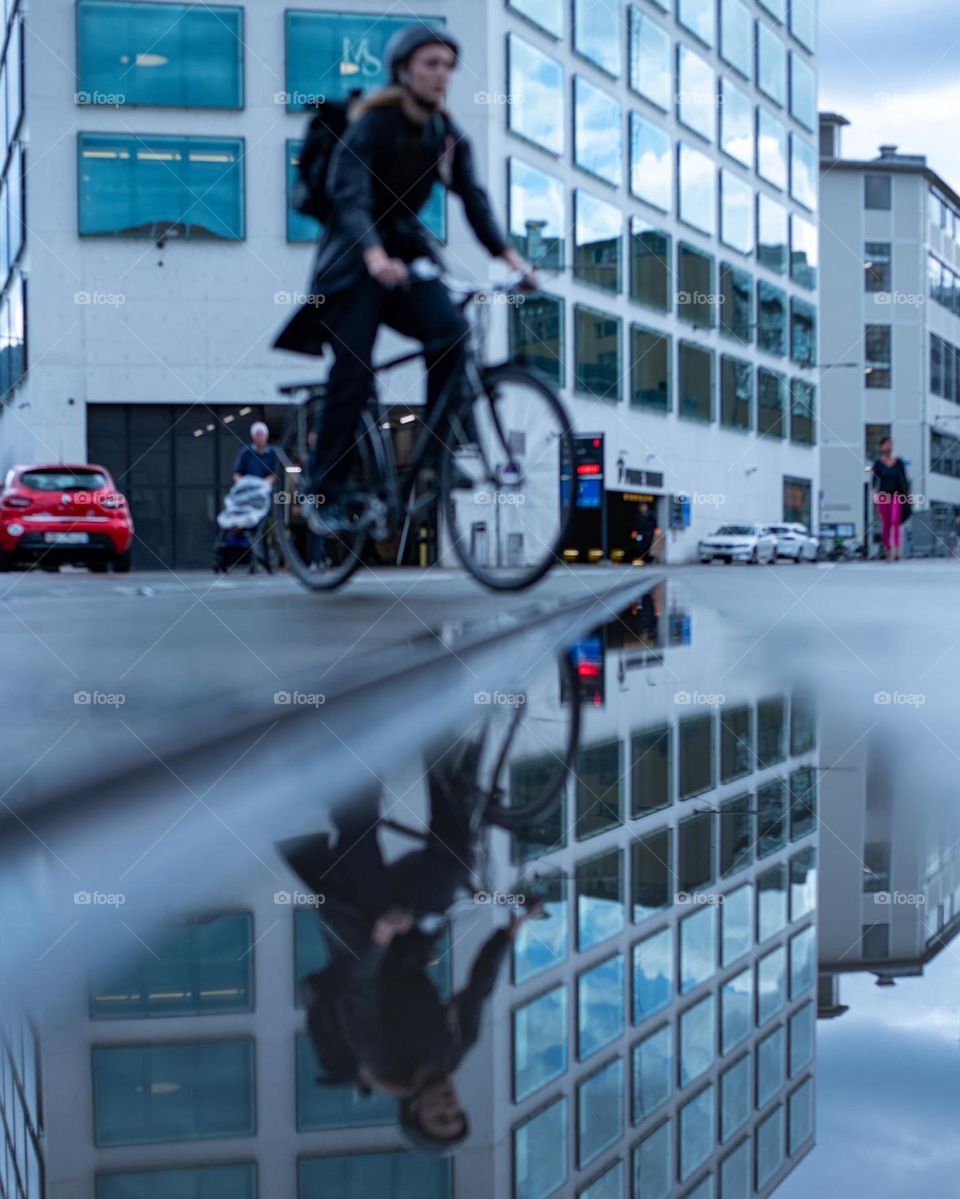 Reflection of a female in a puddle