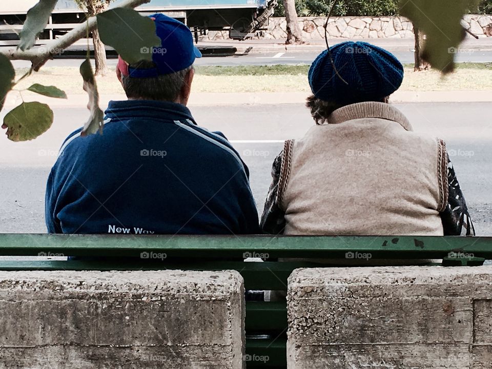 An elderly couple on a bench
